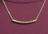 Gold necklace with texts etched on it